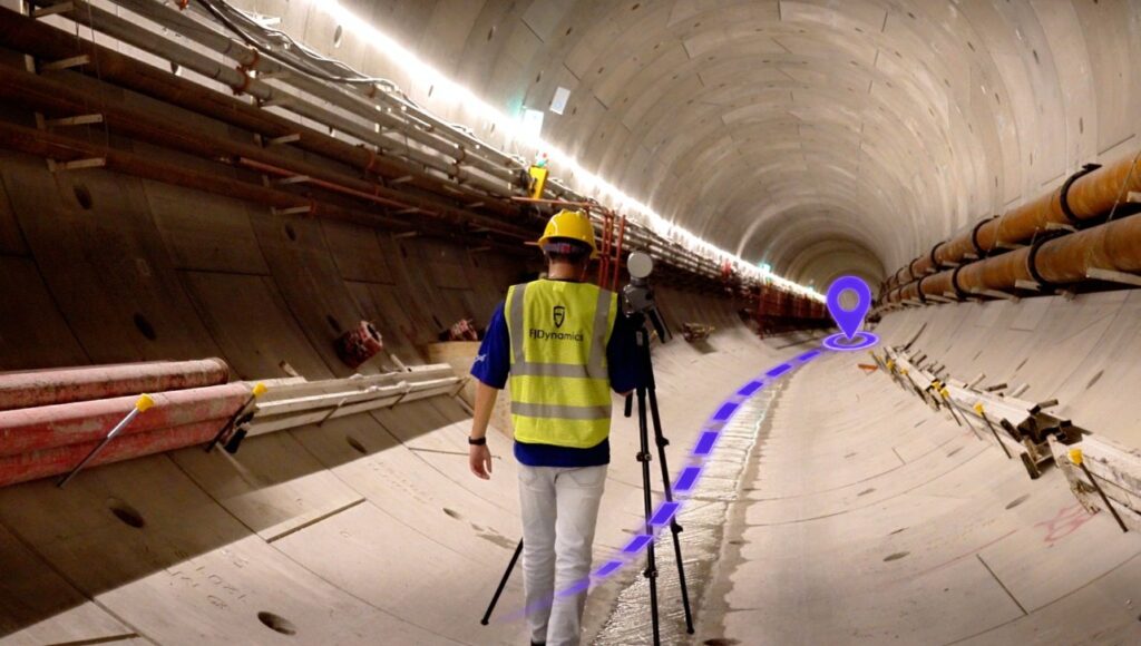 Operator walking between FJD Trion T1 tripod stations with the SLAM path shown